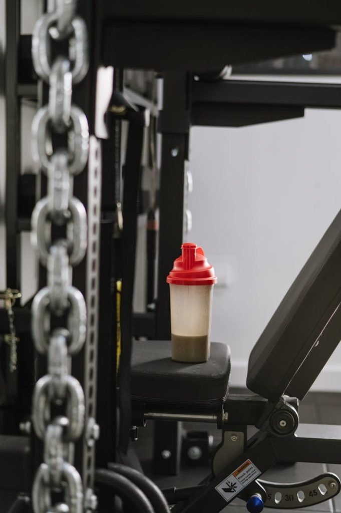 pexels-photo-16513595 A protein shake bottle on gym equipment symbolizing fitness and health.